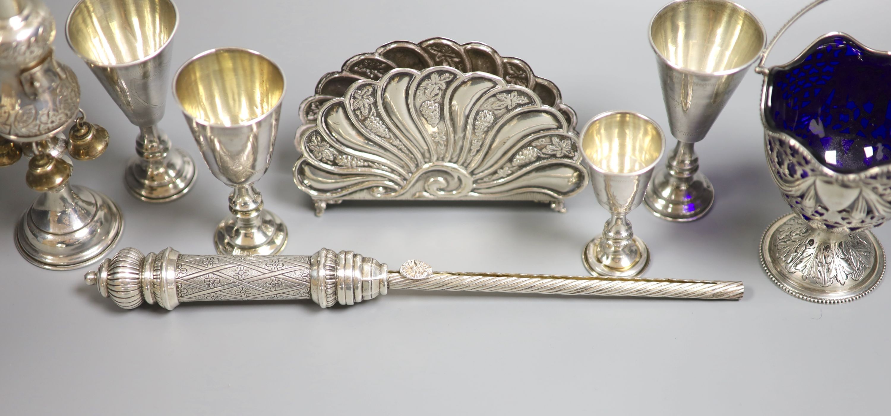 Four George V silver kiddush cups, largest 10.9cm, two other Judaic items, a 925 letter rack, silver napkin ring and Edwardian silver sugar basket.